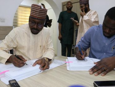 The Head of Project Management Unit (HPMU) of the Nigeria Electrification Project (NEP), Abba Aliyu Abubakar (L) and C.E.O. of ACOB Lighting Tech. Ltd., Mr. Alexander Obiechina (R) at the grant signing.